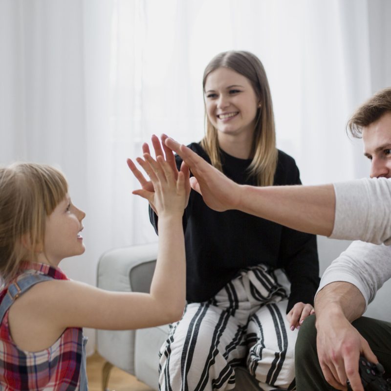 family-high-fiving-living-room